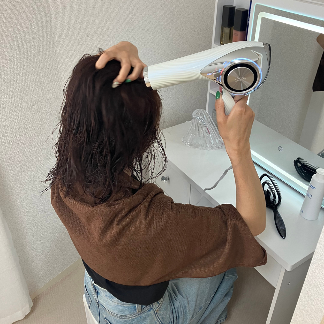 ドライヤーで髪を乾かす様子